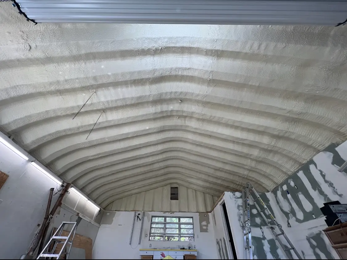 Spray polyurethane foam applied to the underside of a metal roof deck in Compton